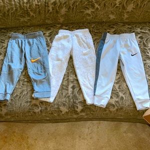 Set of 3 Nike athletic joggers for boys.